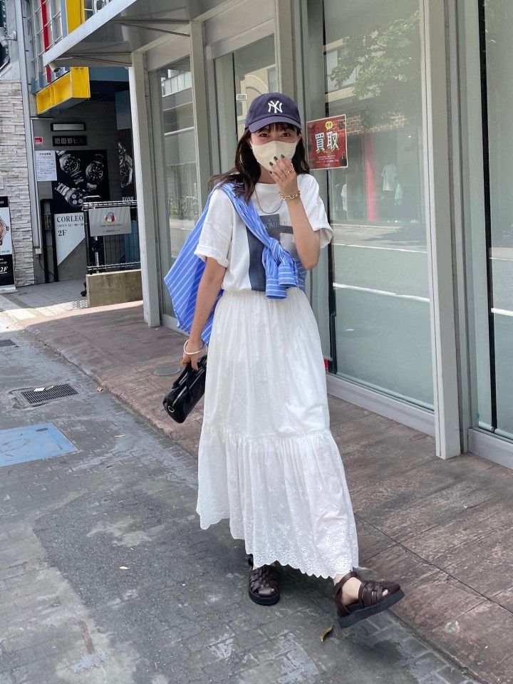 women wearing long skirt and baseball cap